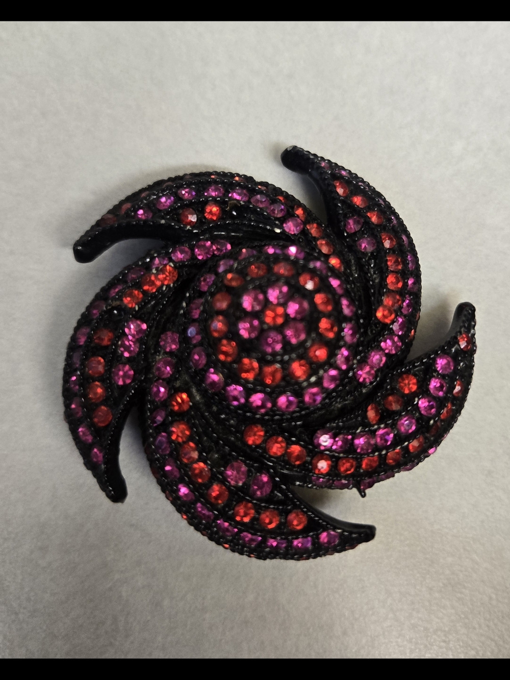 Source Unknown Black Swirl Brooch with Pink & Red Crystals